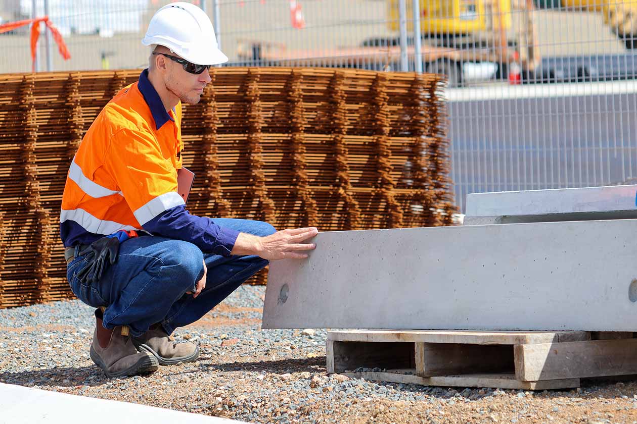 ISO certification inspector assessing construction materials on Australian worksite